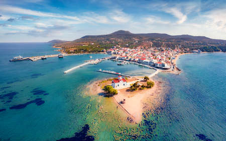 Aerial summer cityscape of Saint Spiridon church and Elafonisos port on background. Fantastic morning seascape of Mediterranean Sea. Sunny outdoor scene of Elafonisos island, Greece, Europe.の写真素材