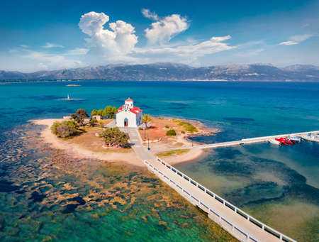 View from flying drone of Saint Spiridon church in Elafonisos port.Colorful morning seascape of Mediterranean Sea. Spectacular outdoor scene of Elafonisos island, Greece, Europe. Travel concept background.の写真素材