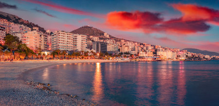 Exciting evening cityscape of Saranda port. Dramatic sunrise on Ionian sea. Perfect outdoor scene of Albania. Travel concept background.の写真素材