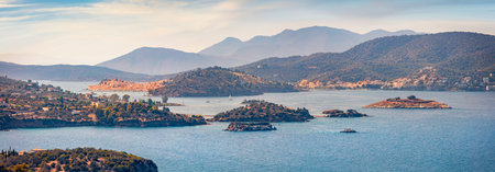 Panoranic summer cityscape of Poros town. Aerial morning seascape of Mediterranean sea with lots of islands. Colorful outdoor scene of Peloponnese peninsula, Greece. Travel concept background.の写真素材