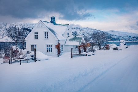Dramatic winter scene of Justad fishing village on Vestvagoy island. White wooden hous on Lofoten Islands, traditional Norwegian architecture. Travel concept background.の写真素材