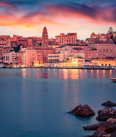 Fantastic evening cityscape of Gaeta town, Cathedral Basilica of Gaeta church on background. Unbelievable summer sunset on the coast of Mediterranean sea, Italy, Europe. Travel concept background.の写真素材