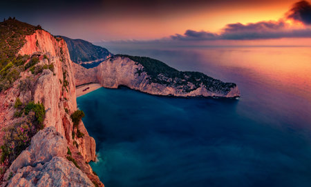 Unbelievable summer view of Shipwreck Beach. Dramatic sunset on Ionian Sea, Zakinthos island, Greece, Europe. Beauty of nature concept background. beautiful summer scenery.の写真素材