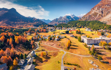 Superb autumn view from flying drone of Maloja village. Picturesque morning scene of Swiss Alps, Switzerland, Europe. Travel concept background.の写真素材