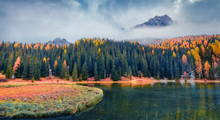 beautiful autumn scenery. Breathtaking morning scene of Misurina lake in National Park Tre Cime di Lavaredo. Dramatic autumn view of Dolomite Alps, Italy, Europe. Beauty of countryside concept background.の写真素材