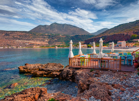Spectacular summer cityscape of Neo Itilo village. Hospitable cafe on the shore of the Ionian sea. Wonderful morning scene of Peloponnese peninsula, Greece, Europe. Travel concept background.の写真素材