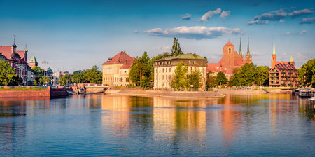 Bright summer cityscape of Wroclaw, Poland, Europe. Beautiful morning view of Tumski island with cathedral of St. John on Odra River. Travel concept background.の写真素材