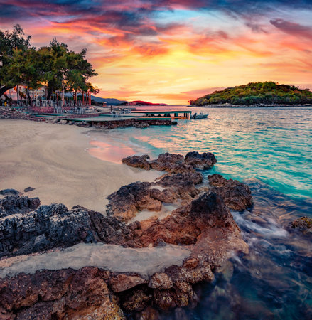 Superb spring sunset in Ksamil town. Spectacular evening seascape of the Ionian sea. Marvelous outdoor scene of Butrint National Park, Albania, Europe. Travel concept background.の写真素材