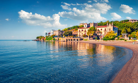 Stunning morning view of historical landmark - Torre della Specola and Santa Croce church. Bright summer cityscape of Sapri town, Italy. Beautiful mediterranean seascape. vacation concept background.の写真素材