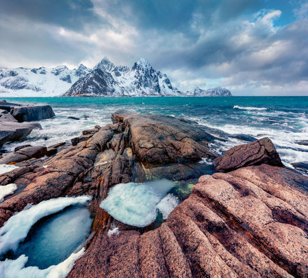 Gloomy spring view of Lofoten Islands. Melting snow on Flakstadpollen fjord. Spectacular morning seascape of Norwegian sea. Beauty of nature concept background.の写真素材
