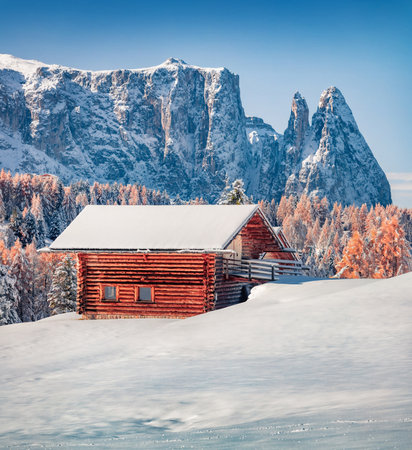 Untouched winter landscape. Bright morning view of Alpe di Siusi village with wooden chalet. Frosty winter scene of Dolomite Alps. Ski resort in Italy, Europe. vacation concept background.の写真素材