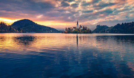 Dranatic morning view of Pilgrimage Church of the Assumption of Maria. Great autumn sunrise on Bled lake, Julian Alps, Slovenia, Europe. Travel concept background.の写真素材