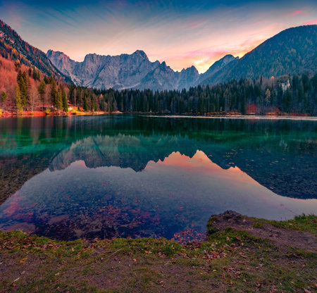 Astonishing morning view of Fusine lake. Superb autumn sunrise in Julian Alps with Mangart peak on background, Province of Udine, Italy, Europe. beauty of nature concept background.の写真素材