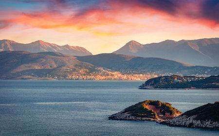 Long focus picture of Saranda town. Amazing morning seascape if Ionian sea. Splendid sunrise in Butrint National Park, Albania, Europe. Travel concept background.の写真素材
