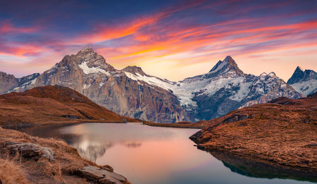 Fantastic evening view of Bachalp lake (Bachalpsee), Switzerland. Amazing autumn sunset in Swiss alps, Grindelwald, Bernese Oberland, Europe. beauty of nature concept background.の写真素材