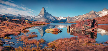 Panoramic morning view of Stellisee lake with Matterhorn/Cervino peak on background. Colorful autumn scene of Swiss Alps, Zermatt location, Switzerland, Europe. beauty of nature concept background.の写真素材