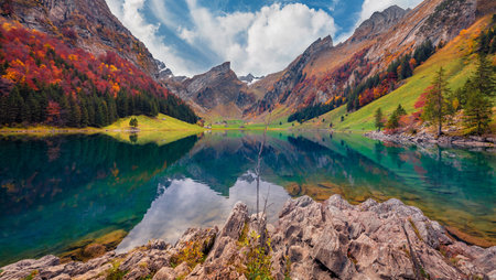 beautiful autumn scenery. Amazing morning view of the Swiss Alps. Santis peak reflected in the calm surface of pure water of lake. Unbelievable autumn scene of Seealpsee lake, Switzerland.の写真素材