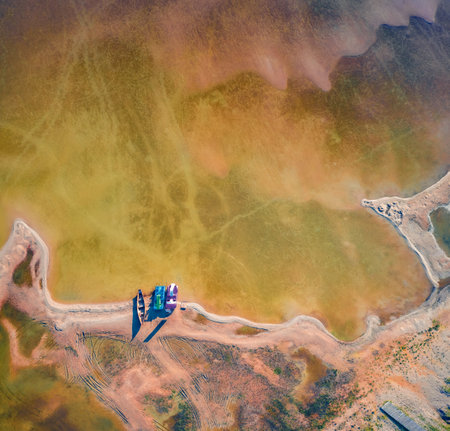 aerial landscape photography. Straight down view from flying drone of shore and fishing boats on...
