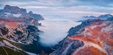 Foggy autumn view of Tre Cime Di Lavaredo National Park. Majestic evening scene of Dolomite Alps, Auronzo Di Cadore location. Sunset in Italy. beauty of nature concept background.の写真素材