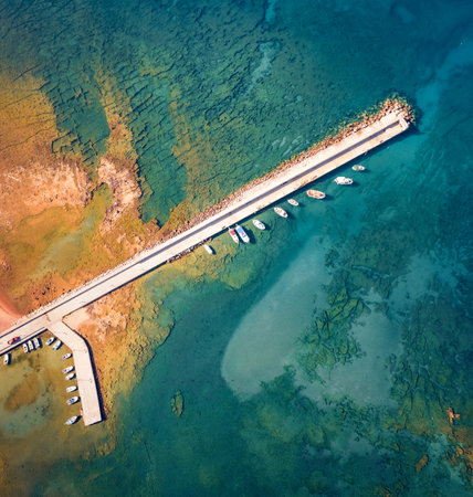 Straight down view from flying drone of pier in Kardamyli port. Colorful morning seascape of Ionian sea. Bright outdoor scene of Peloponnese peninsula, Greece. Travel concept background.の写真素材