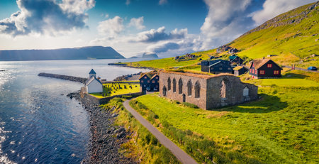 Panoramic summer view from flying drone of Kirkjubour village with Hestur Island on background. Captivating morning scene of Faroe Islands, Denmark, Europe. Travel concept background.の写真素材