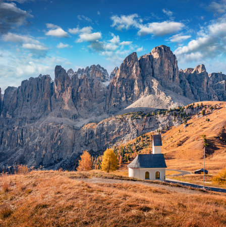 Small chapel on the top of Gardena pass with Piz Boe mountain on background. Stunning autumn view of Dolomite Alps, Canazei, Province of Trento, Italy, Europe. Travel concept background.の写真素材