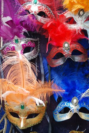 Colourful masks on a market stall ready for carnival goers to buy and wear の写真素材