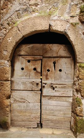 An old wooden door in Tuscany, Italy with the word 'lavatoi' meaning washrooms on it の写真素材