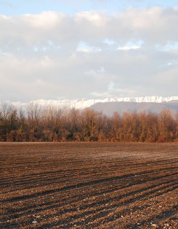 A field in December in the Friuli region of north east Italy. Deep shadows are cast in the freshly ploughed from the low sun of the late afternoon. の写真素材