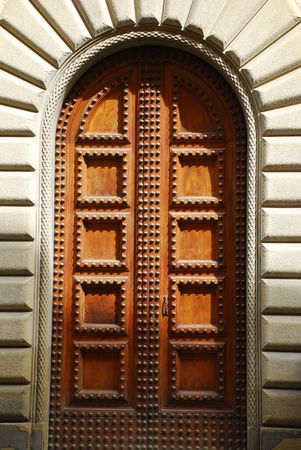 A heavy wooden door in Arezzo, Tuscany, in the late afternoon's partial shade の写真素材