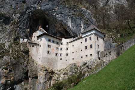 The historic Predjama Grad castle in Slovenia which dates back to the twelfth century. The fairytale-like castle is located in a limestone cliff in a cave entrance.の写真素材