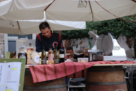 Udine, Italy, 09.21.08:A stall selling wine and ham. The stall is part of the annual Friuli Doc festival which celebrates the food, drink and craft of the regionのeditorial素材