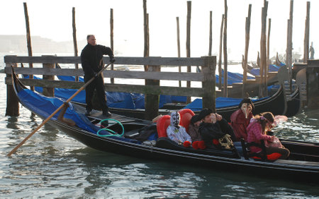 Venice, Italy, 02.21.09: Carnival goers in costume enjoy a gondola trip along the canals at the Venice Carnivalのeditorial素材