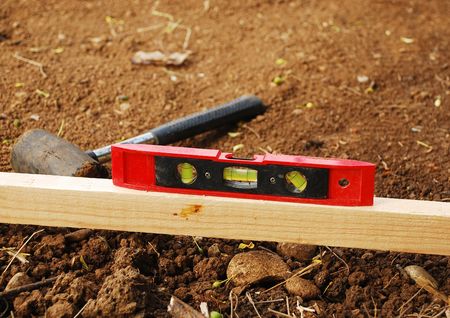 A small patch of land which has been levelled in preparation for the construction of a garden shed....