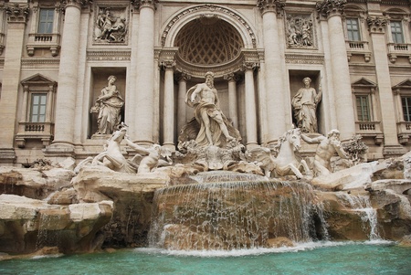 The Baroque Trevi Fountain in Rome. Oceanus stands at the centre and is flanked by Tritons, the left calming a horse and the right blowing through a conch shell の写真素材