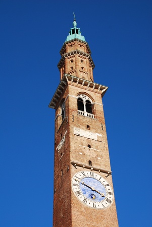 The Torre Bissara clocktower on the Basilica Palladiana in Piazza dei Signori, Vicenza, Italy. Originally constructed in the 15th century, this UNESCO World Heritage Site Renaissance building was later partly reconstructed by Palladio の写真素材