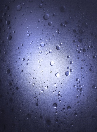 Light shines through a plastic shower door with a bubble-effect surfaceの写真素材