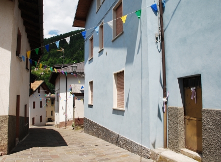 Buildings in the village of Ligosullo in Friuli, north east Italy  The street is decorated in bunting in celebration of the annual village fete の写真素材