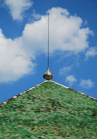 A green tiled roof on an historic Italian buildingの写真素材