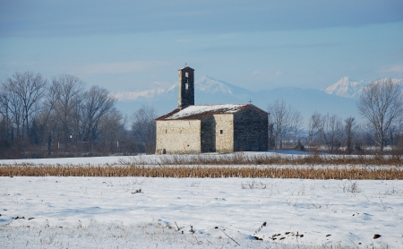 A rural church in a snowy field in the north east Italian region of Friuliの写真素材