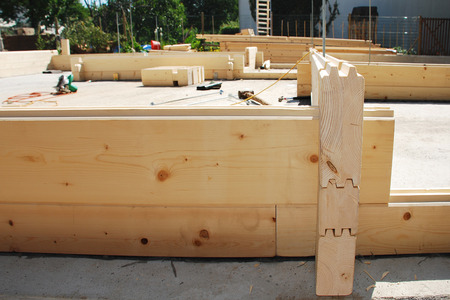 A partially constructed wood  fir  prefabricated block house on a domestic building site  The front door entrance can be seen on the front rightの写真素材