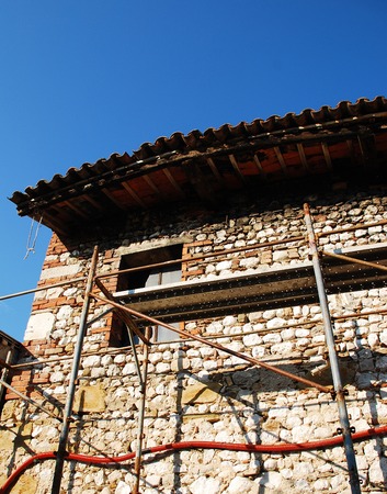 An old Italian stone farmhouse in the process of being demolished  の写真素材