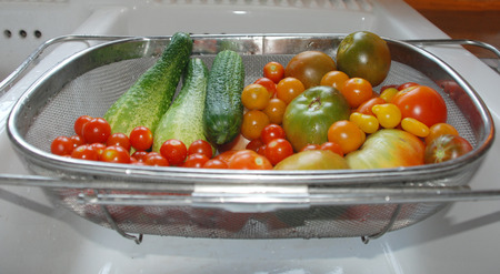 A day s harvest of ripe cucumbers and tomatoes  cherryの写真素材