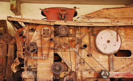 An antique wood corn cob sheller outside an Italian Agricultural Building