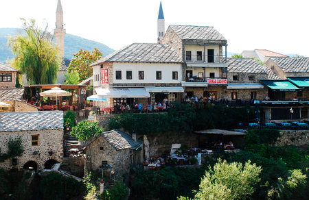 Mostar, Bosnia and Herzegovina - August 13th 2014. Tourists fill busy restaurants near the Old Bridge during peak holiday season in the historic city of Mostar in southern Bosnia and Herzegovinaのeditorial素材