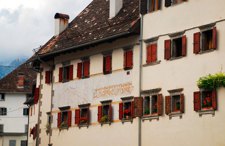 Buildings in the village of Pesariis in the Prato Carnico municipality of Carnia, Friuli, north east Italy. This village is located in the Pesarina Valley and is known as \\\\\\\"the town of clocks\\\\\\\" thanks to its history of clockmaking and the manyのeditorial素材