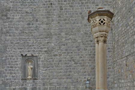 A wall and sculpture inside the historic Adriatic city of Dubrovnikの写真素材