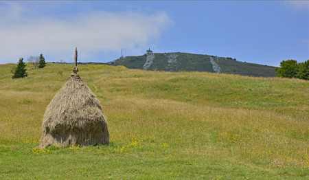 The Matajur mountain in Friuli Venezia Giulia, Italy. The rounded hill with the church in the...