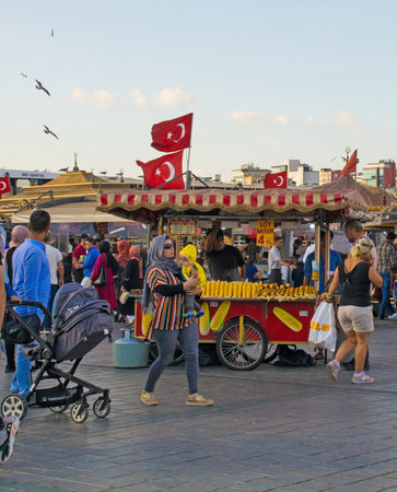Istanbul, Turkey - September 9th 2019. Locals and tourists walk past the many food stalls along the waterfront area of Eminonu in the Fatih district of Istanbulのeditorial素材