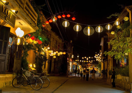 Hoi An, Vietnam - December 20th 2017. Colourful yellow, red and white fabric lanterns hang across a street in the historic UNESCO listed Vietnamese town of Hoi An.のeditorial素材